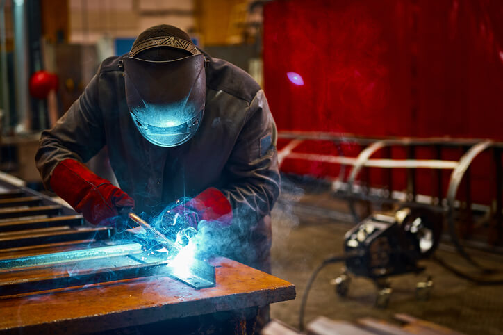 Welder reshaping metal after welder training