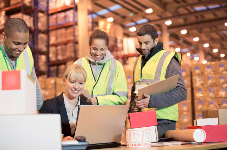 A logistics team working together in a warehouse after logistics courses