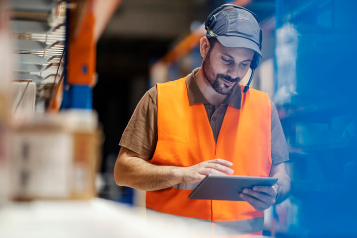 A logistics supervisor checking a shipment after their logistics training