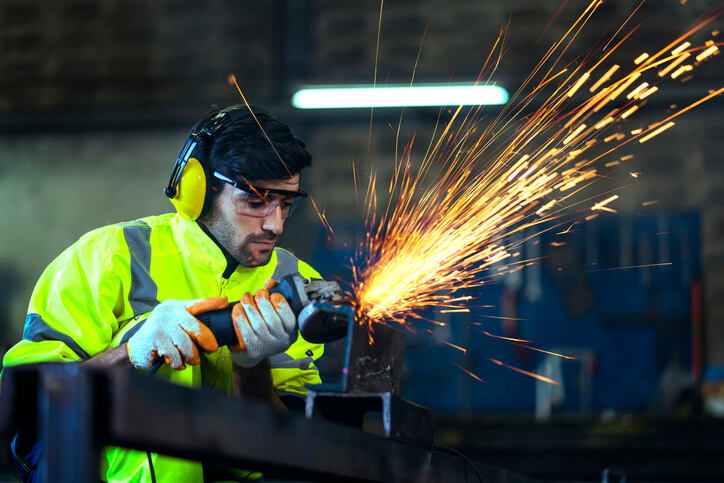 An apprentice millwright performing a welding task during welder training