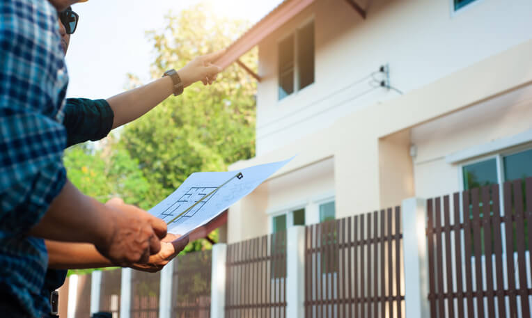 A home inspector examining a property for sale after home inspection training.