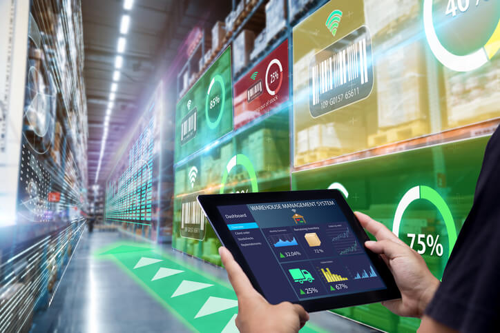 Male logistics manager using warehouse management software after logistics training