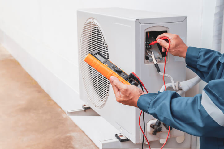 HVAC technician working on an air conditioning system