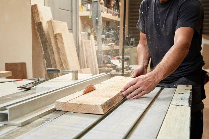 Male cabinet maker in a workshop after his cabinet making training