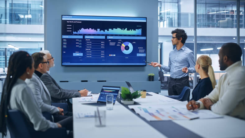 A supply chain professional holding a meeting in an office after supply chain and logistics training