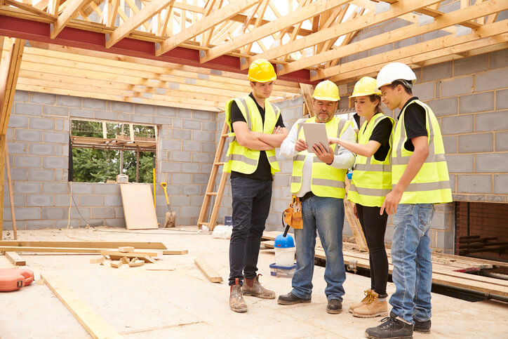 A team of home renovation technicians at a work site after completing their home renovation training