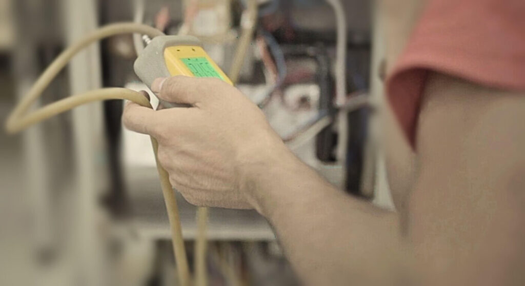 An HVAC technician working on a system after completing HVAC technician training