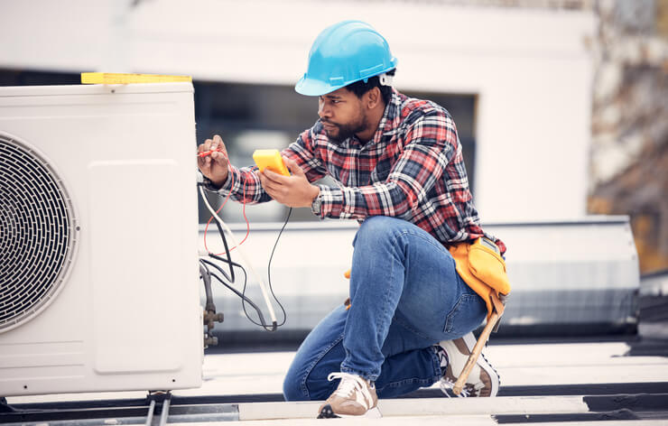 HVAC technician working on an air conditioning system after completing his HVAC technician training