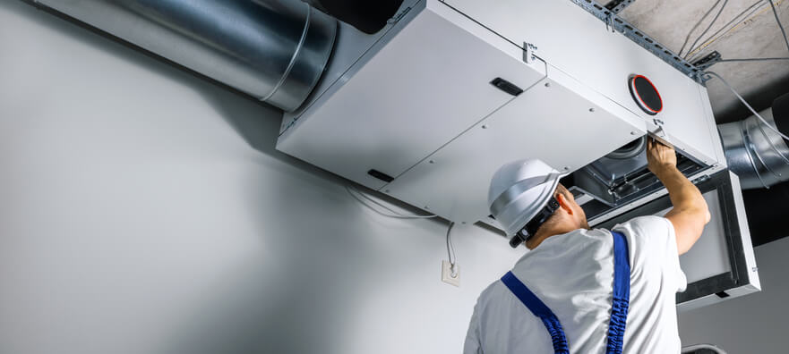 HVAC training graduate working on industrial HVAC System