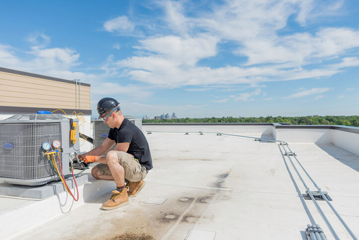 HVAC training graduate working on commercial HVAC System