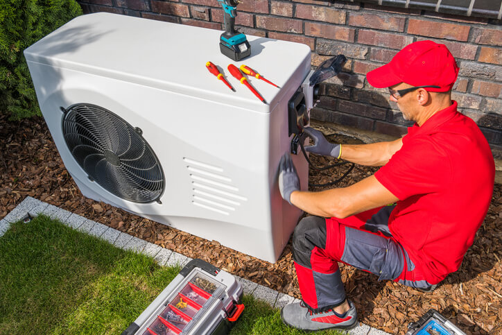 HVAC training graduate working on residential HVAC System