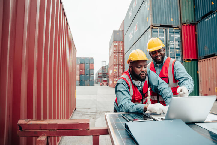 A pair of male operation managers at a warehouse after logistics management training
